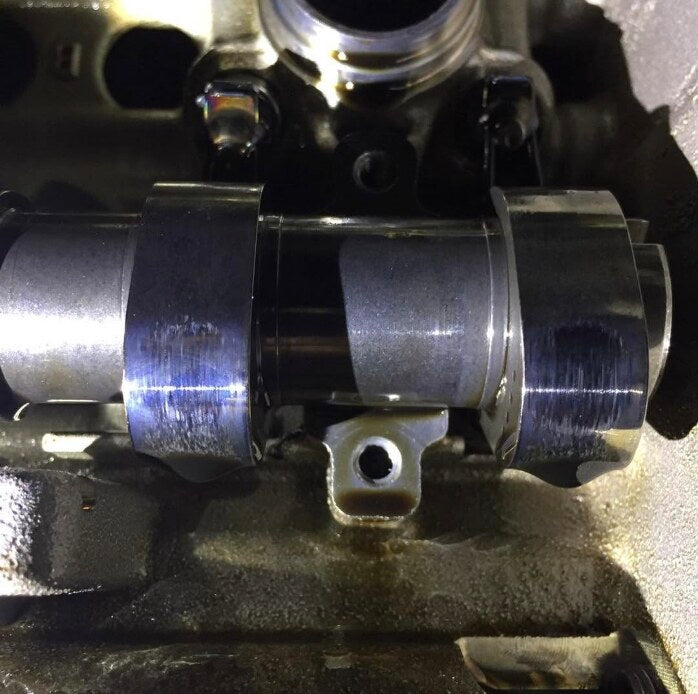 991.1 GT3 camshaft lobes in the head showing wear streaks from worn finger followers